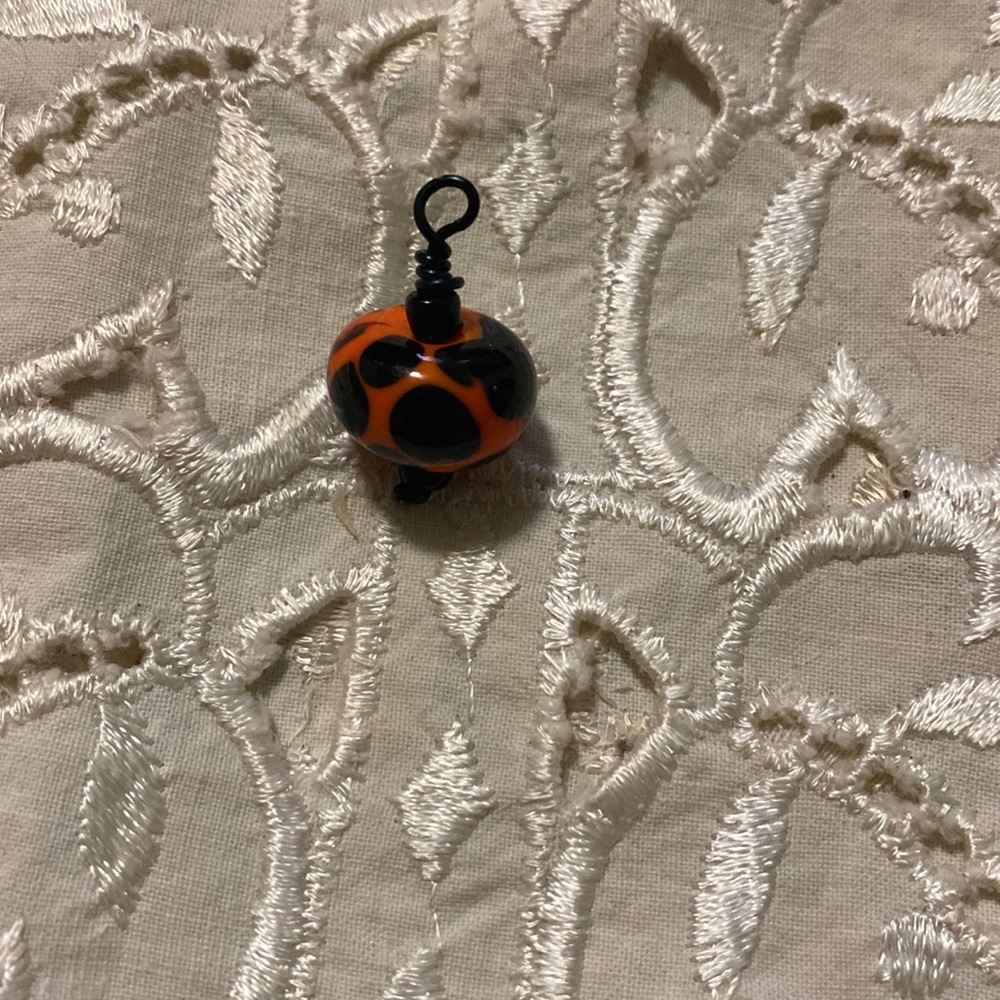 Orange & black blown glass bead pendant